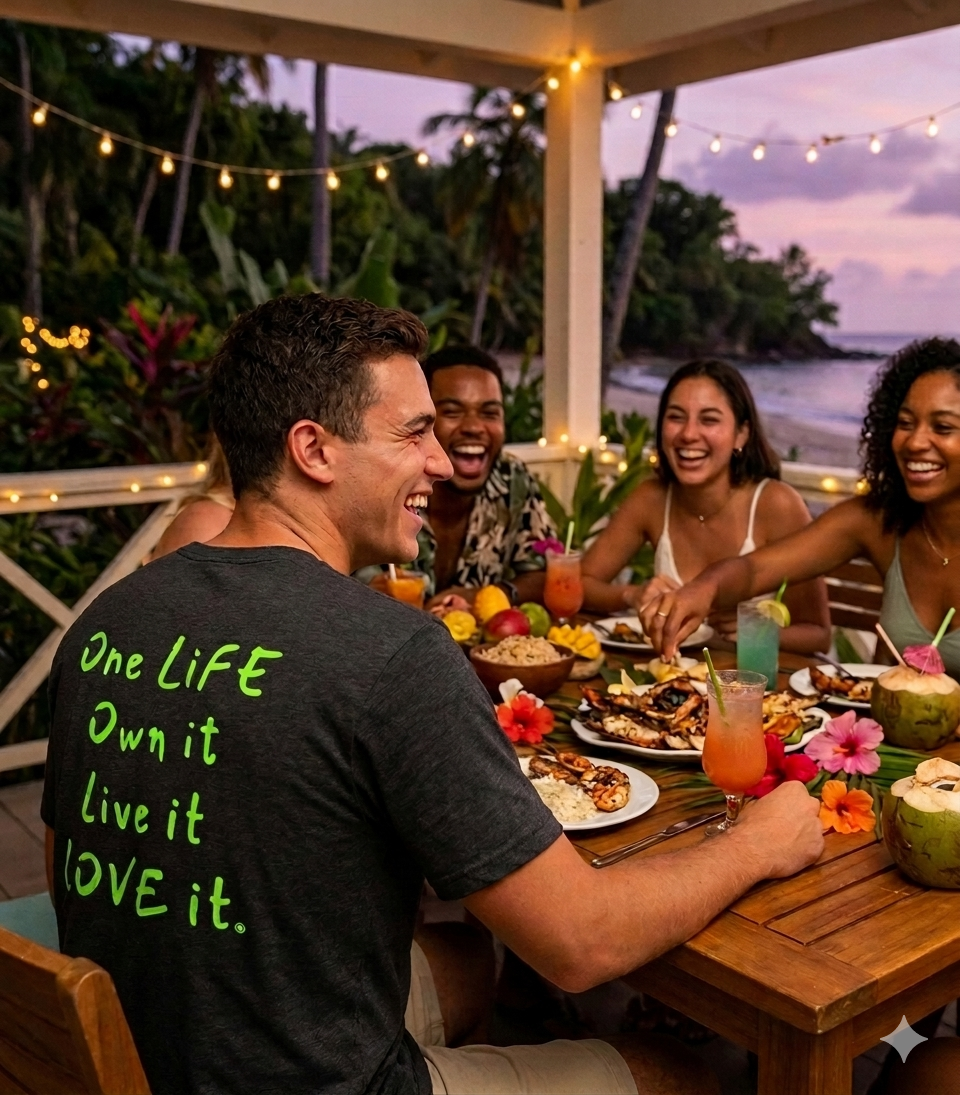 Group of people enjoying a meal together outdoors with a scenic background.